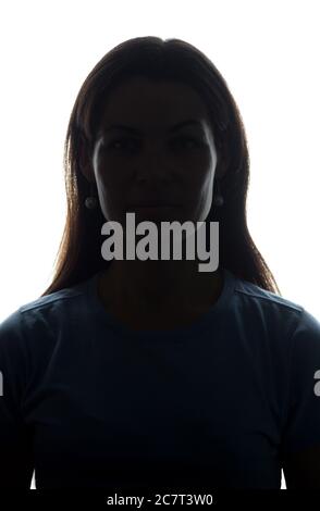 Young woman look ahead with flowing hair - vertical, isolated silhouette of a front view Stock Photo