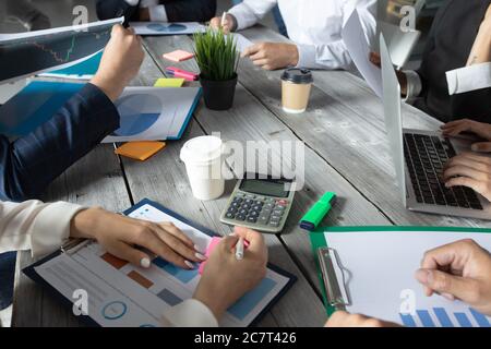 Business corporate management planning team concept, people sitting around office table and working with financial data reports Stock Photo