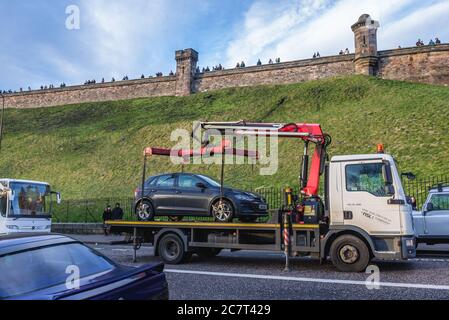 Tow truck lifted illegaly parked car on Johnston Terrace street in Edinburgh, the capital of Scotland, United Kingdom Stock Photo