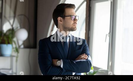 Pensive Caucasian businessman look in distance thinking Stock Photo