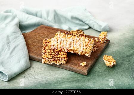 Board with crispy rice bars on color background Stock Photo