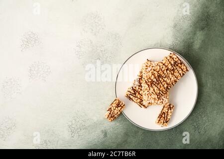 Plate with crispy rice bars on color background Stock Photo