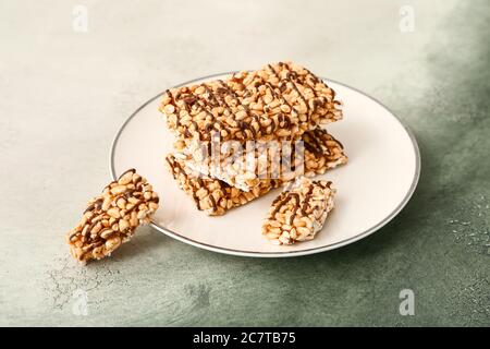 Plate with crispy rice bars on color background Stock Photo