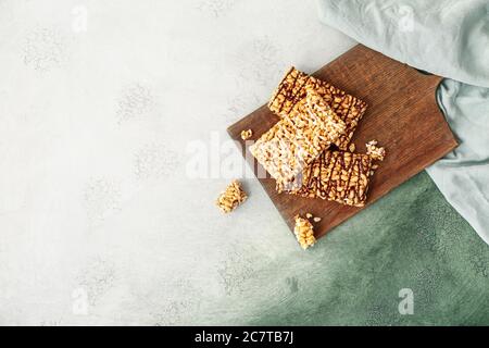 Board with crispy rice bars on color background Stock Photo