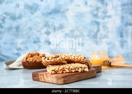 Board with crispy rice bars on color background Stock Photo