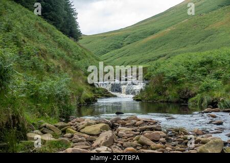 Alport Dale is a remove valley in the Peak District National Park with mant waterfalls and the famous Alport Castles, a major landslip Stock Photo