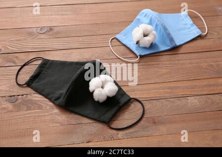 Cotton protective masks on wooden background Stock Photo
