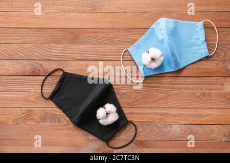Cotton protective masks on wooden background Stock Photo