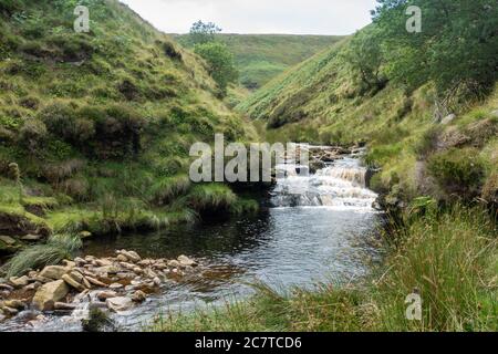 Alport Dale is a remove valley in the Peak District National Park with mant waterfalls and the famous Alport Castles, a major landslip Stock Photo