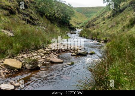 Alport Dale is a remove valley in the Peak District National Park with mant waterfalls and the famous Alport Castles, a major landslip Stock Photo