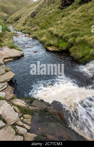 Alport Dale is a remove valley in the Peak District National Park with mant waterfalls and the famous Alport Castles, a major landslip Stock Photo