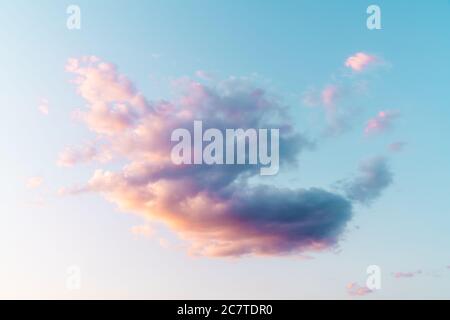 Sunrise, the sun is shining strong from the horizon over all the clouds and under the blue sky. High quality photo Stock Photo