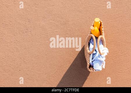 Bag with sunscreen cream on beach Stock Photo