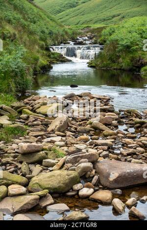 Alport Dale is a remove valley in the Peak District National Park with mant waterfalls and the famous Alport Castles, a major landslip Stock Photo