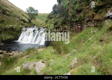 Alport Dale is a remove valley in the Peak District National Park with mant waterfalls and the famous Alport Castles, a major landslip Stock Photo