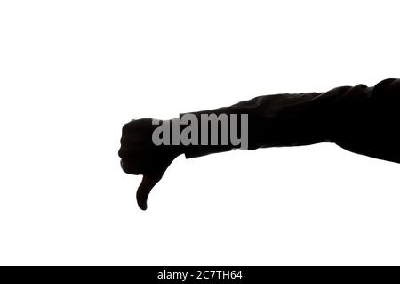 Man's hand shows a symbol of a thumb down - silhouette Stock Photo