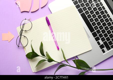 Composition with notebook and laptop on color background Stock Photo