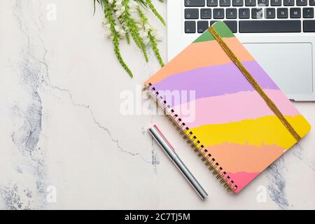 Notebook with laptop on white background Stock Photo