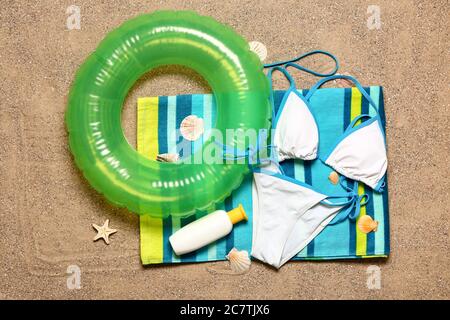 Set of beach accessories on sand, top view Stock Photo