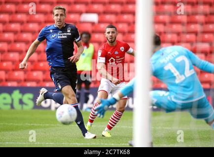 Barnsley's Conor Chaplin (centre) has a shot on goal during the Sky Bet Championship match at Oakwell, Barnsley. Stock Photo