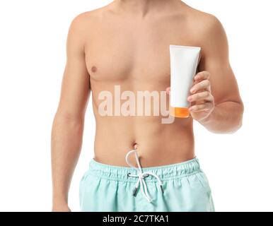 Young man with sun protection cream on white background Stock Photo