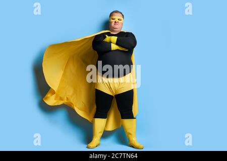 serious overweight super hero man is defender of the universe, strong guy has a mad desire, a dream to shield the world from dirt and evil Stock Photo