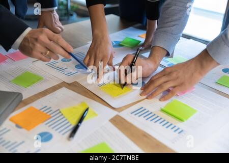 Close up of diverse employees analyze financial documents Stock Photo