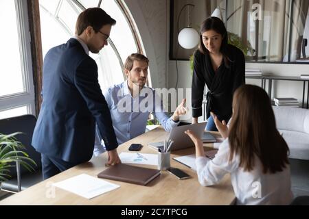 Multiracial employees engaged in team discussion at meeting Stock Photo