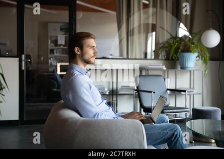 Caucasian businessman distracted from office computer work thinking Stock Photo