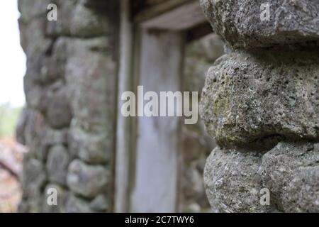 Close-up shot of doorframe of old stone ruins of a forgotten lodge Stock Photo