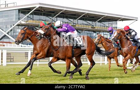 Karibana ridden by Shane Kelly (second left) goes on to win The Cash Out At bet365 Handicap at Newbury Racecourse. Stock Photo