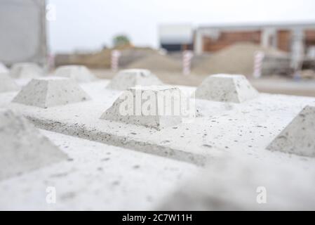 Selective focus of interlocking concrete blocks under the sunlight with a blurry background Stock Photo