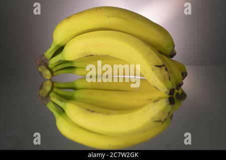 Yellow bananas on mirroring table. Gorizontal image Stock Photo