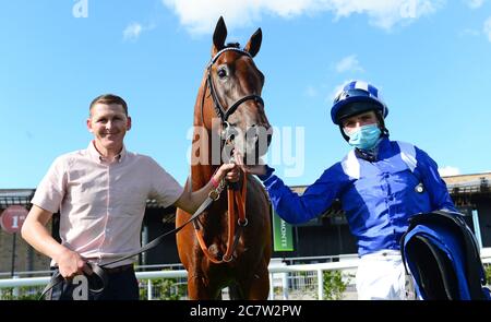 Monaasib and jockey Chris Hayes with groom Dessie Cummins after winning the Irish EBF Median Sires Series Maiden at Curragh Racecourse. Stock Photo