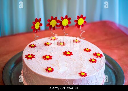 Big cake decorated with berries and flowers with a first birthday Stock Photo