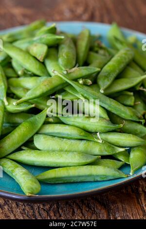 raw peas on dark wood Stock Photo