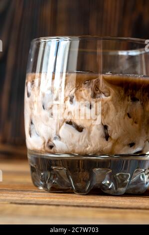 Glass of White Russian cocktail. Combining vodka, coffee liqueur and cream. Stock Photo