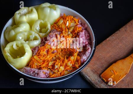 Bowl of raw minced meat and sauteed vegetables for stuffed bell peppers. Vegetables completely ready for filling with meat. Cooking dinner. Part from Stock Photo