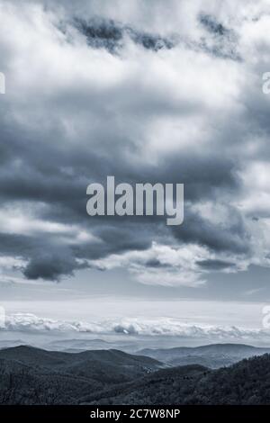 Giant clouds hover over the mountains, threatening rain, on the Blue Ridge Parkway near Asheville, NC, USA Stock Photo