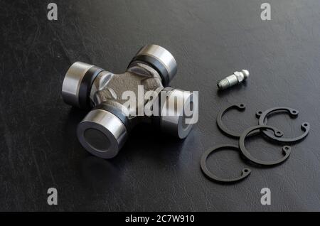 Cross joint for propeller shaft and set of circlips. Trade Auto parts, car service. Automotive industry. Selective focus. Stock Photo