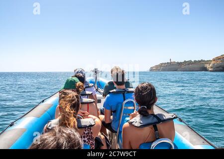 A group of tourist in a boat visiting the caves of Benagil Stock Photo