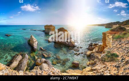 Picturesque seascape with white rocky cliffs, sea bay, islets and faraglioni near by beach Spiaggia della Punticeddha, Salento Adriatic sea coast, Pug Stock Photo