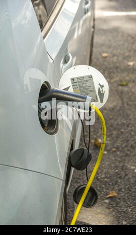 London, England - June 2018:  Close up view of a charging lead for an electric car plugged into its socket. Stock Photo