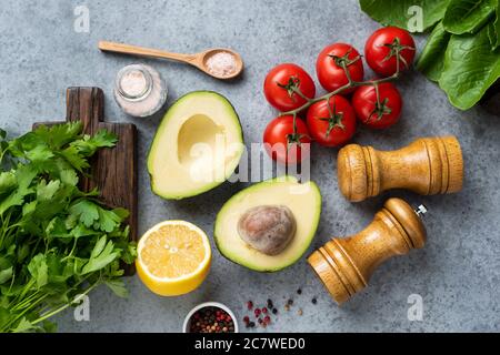 Fresh cooking ingredients and spices on concrete background. Top view. Vegan, vegetarian cooking concept Stock Photo