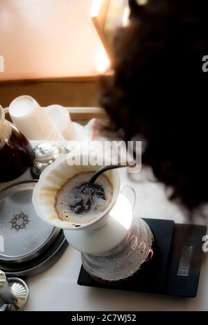 Making pour-over coffee with a hario V60 dripper. Stock Photo