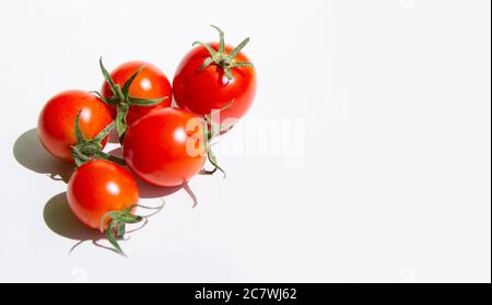 Red cherry tomatoes on a white background, arranged in a group.copyspace for text Stock Photo