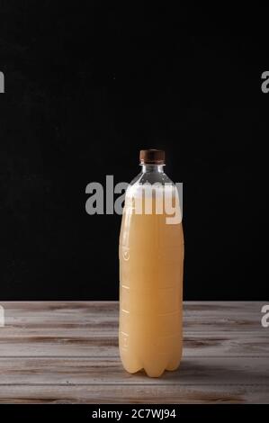 White plastic bottle of beer or light rye kvass on wooden background with copy space for text. Rustic style Stock Photo