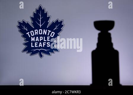 TORONTO, CANADA, 17. JULY: Toronto Maple LeafsLogo of NHL club on the screen. Stenley Cup Trophy Silhouette. Stock Photo