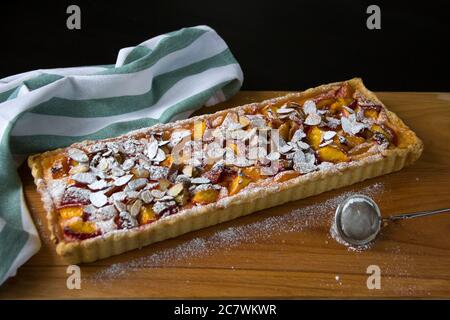 Dessert, shortcrust pastry pie with cottage cheese and summer fruits, figs, peaches, apricots Stock Photo