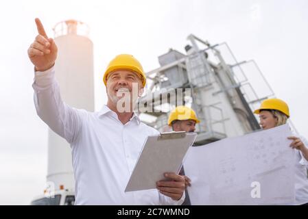 Low angle shot of a caucasian male engineer pointing his finger Stock Photo